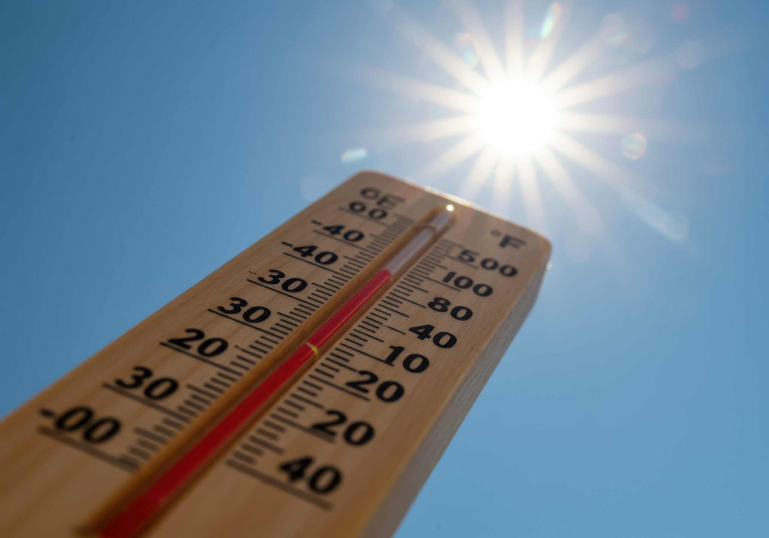 Extreme heat weather thermometer reading under bright sunshine sky